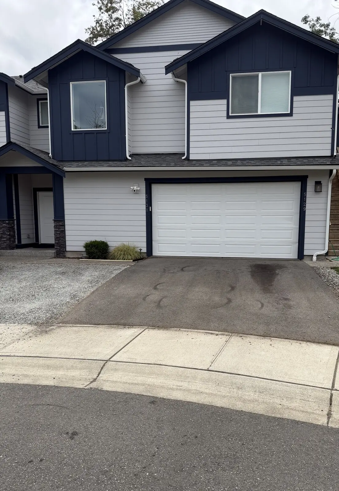 Chad's own SeaTac driveway before sealcoating: faded gray asphalt in front of his house.