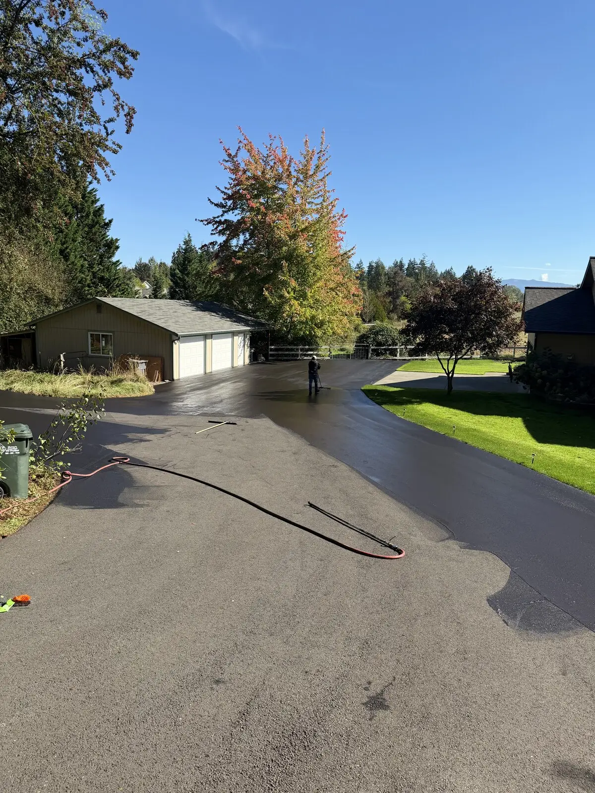 Sealing underway, with the hose run out across the freshly coated turnaround.