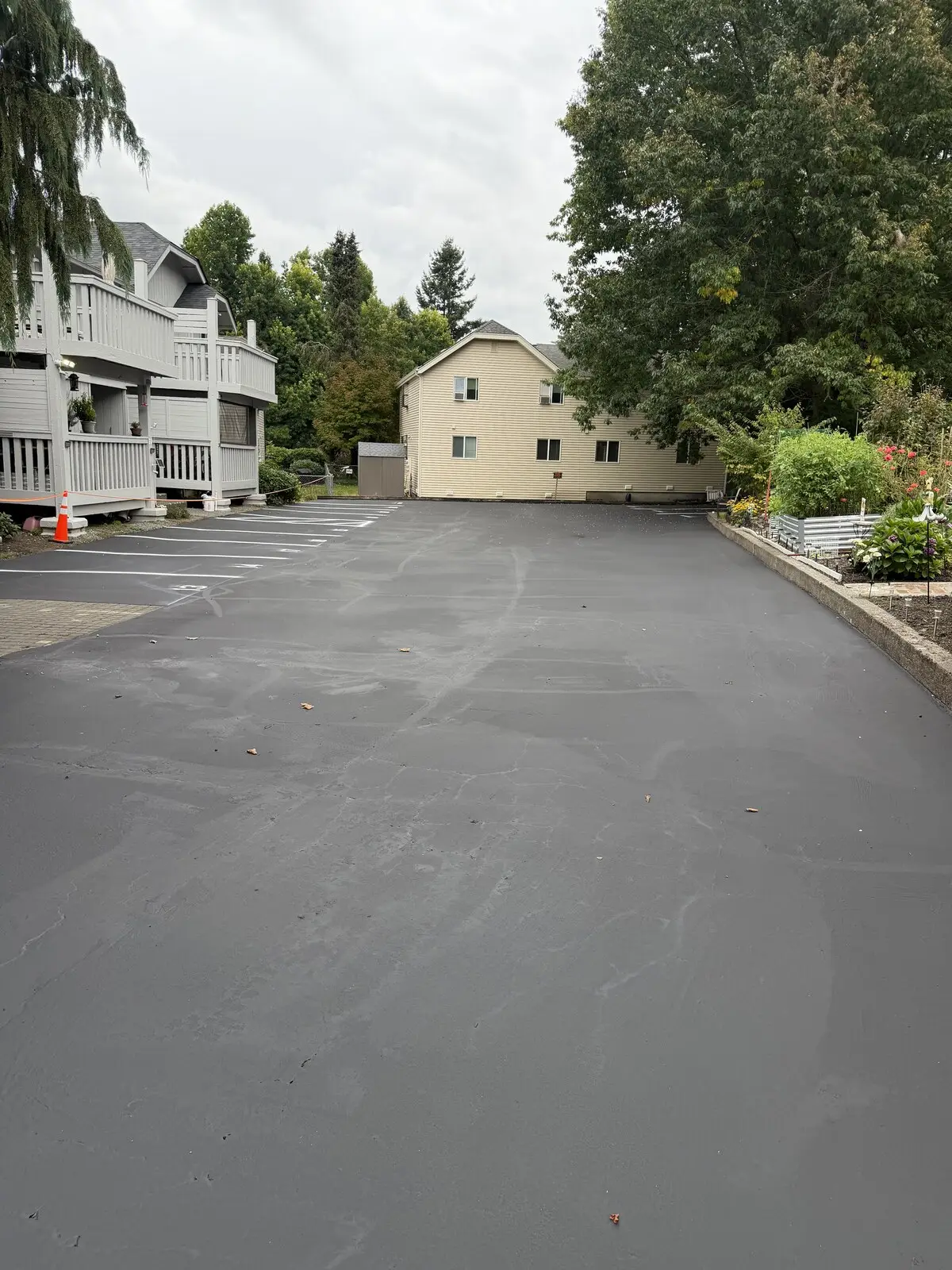 The finished lot, sealed dark and restriped with crisp white stall lines.
